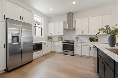 a kitchen with stainless steel appliances and white cabinets