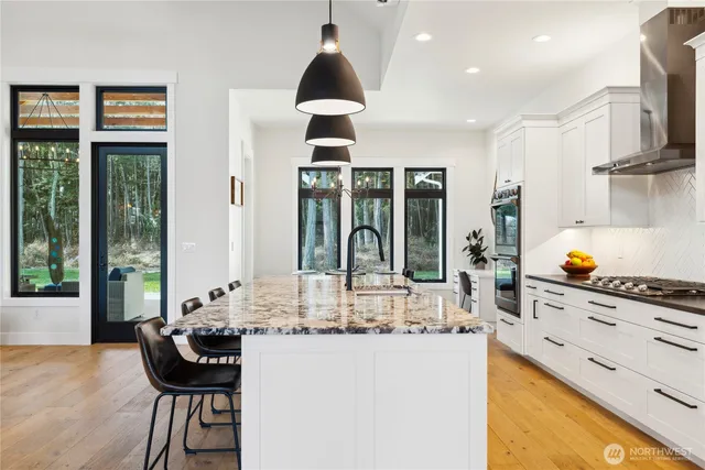 a kitchen with stainless steel appliances granite countertop a stove and a sink