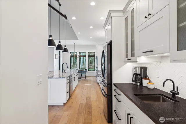 a kitchen with counter top space a sink and cabinets