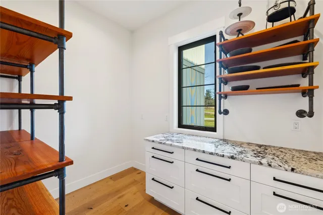 a bathroom with a sink a mirror and a window