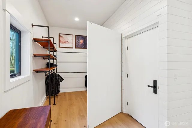 a view of a hallway with frames and frames on wall