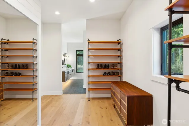 a view of walk in closet with empty racks