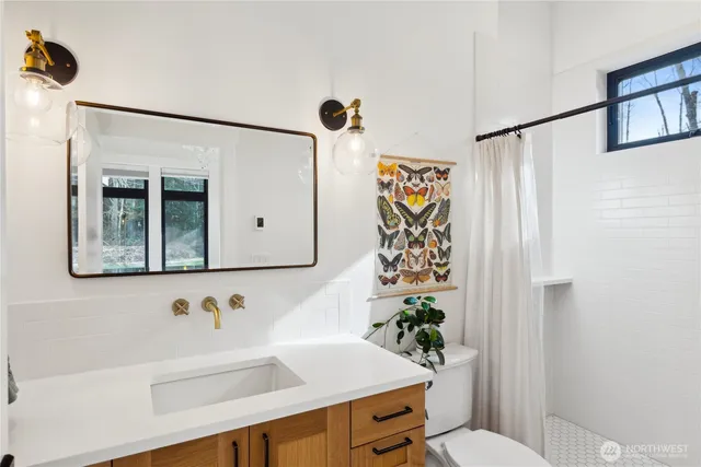 a bathroom with a sink toilet and mirror