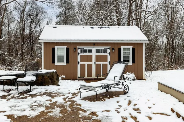 a front view of a house with a yard covered in snow