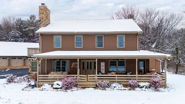 a front view of a house with a yard table and chairs