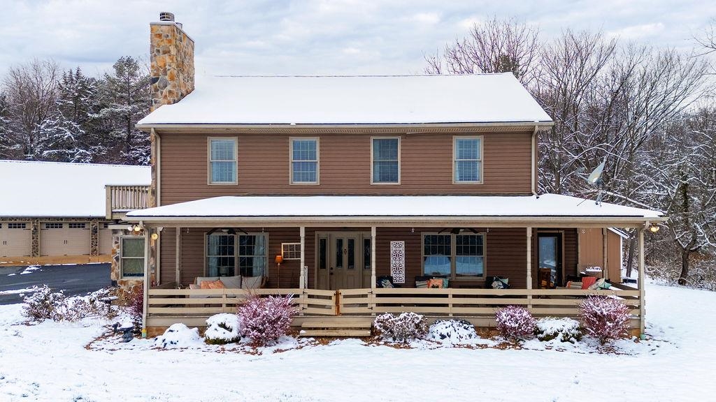 840 Commerce Road Staunton, VA 24401 - Photo 2 of 67 a front view of a house with a yard table and chairs