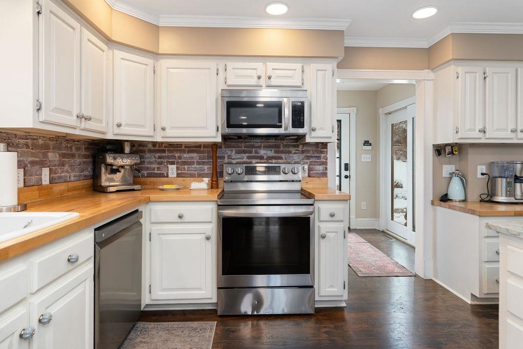 840 Commerce Road Staunton, VA 24401 - Photo 24 of 67 a kitchen with stainless steel appliances granite countertop a stove and a refrigerator