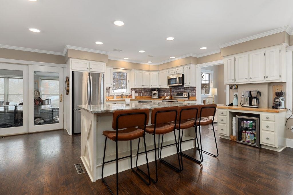 840 Commerce Road Staunton, VA 24401 - Photo 25 of 67 a kitchen with stainless steel appliances kitchen island granite countertop a refrigerator and a stove top oven