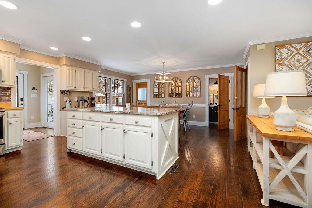 840 Commerce Road Staunton, VA 24401 - Photo 27 of 67 a kitchen with stainless steel appliances kitchen island granite countertop a stove a sink and a refrigerator