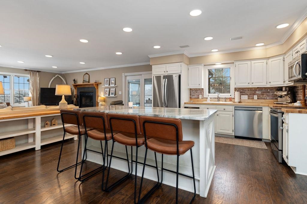 840 Commerce Road Staunton, VA 24401 - Photo 28 of 67 a kitchen with a table chairs refrigerator microwave and cabinets