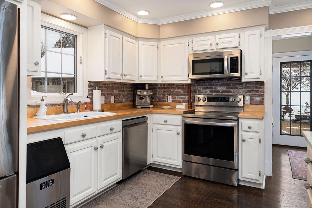 840 Commerce Road Staunton, VA 24401 - Photo 29 of 67 a kitchen with cabinets stainless steel appliances and wooden floor