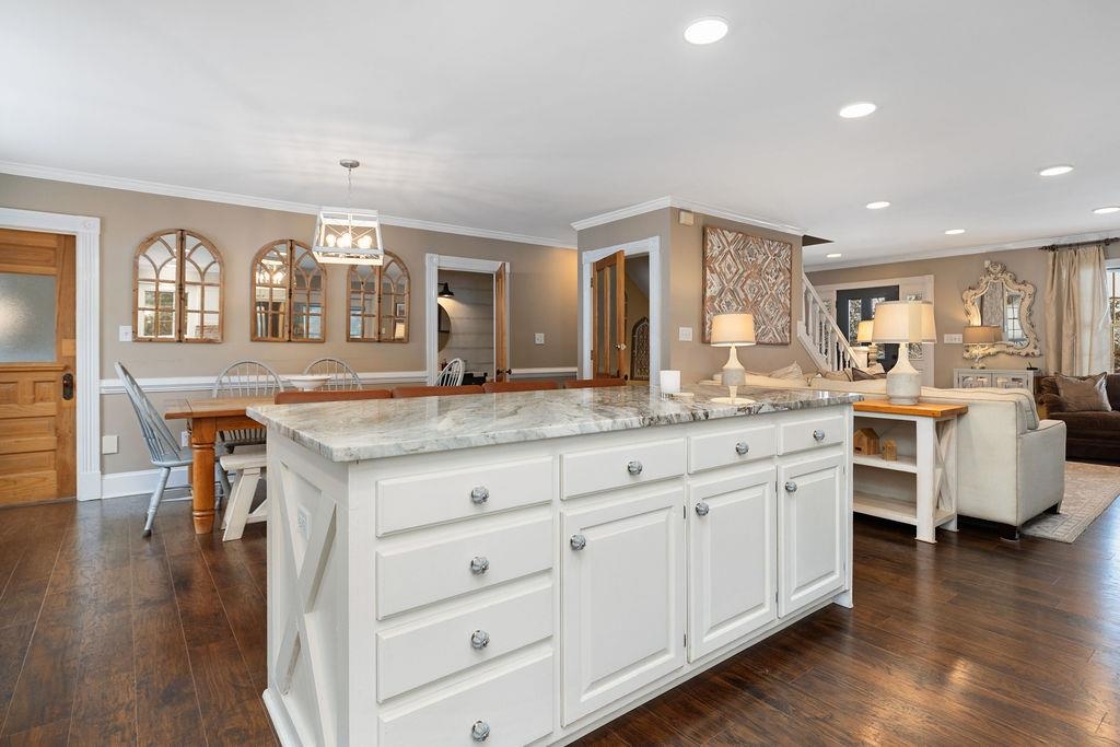 840 Commerce Road Staunton, VA 24401 - Photo 30 of 67 a kitchen with granite countertop a stove a sink and white cabinets with wooden floor next to windows