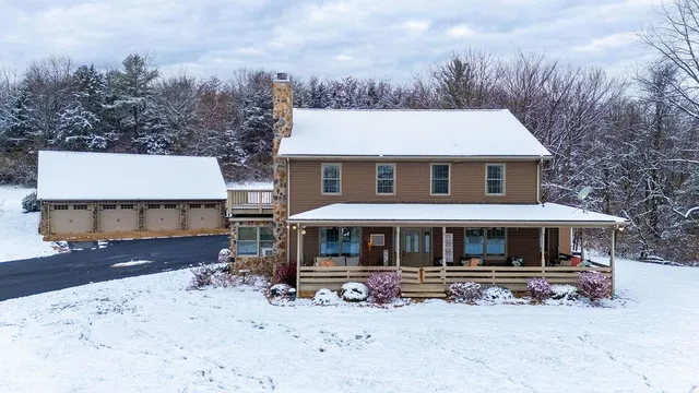a front view of a house with a yard covered with snow in front of house