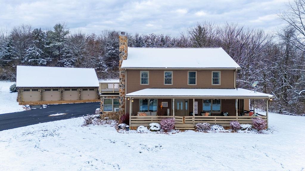 840 Commerce Road Staunton, VA 24401 - Photo 3 of 67 a front view of a house with a yard covered with snow in front of house