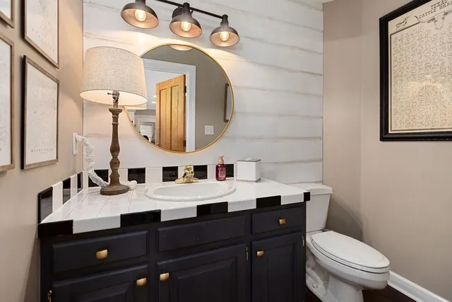 a bathroom with a toilet a sink and shower