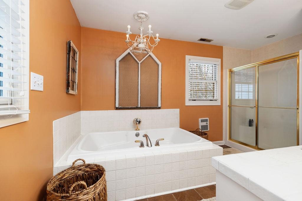 840 Commerce Road Staunton, VA 24401 - Photo 41 of 67 a bathroom with a tub sink and a mirror