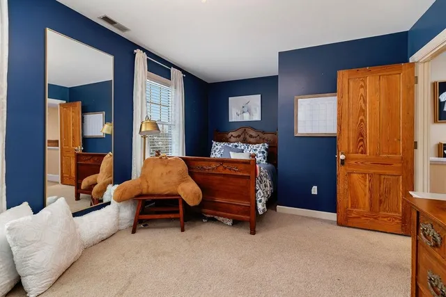 a bedroom with a bed and a view of kitchen