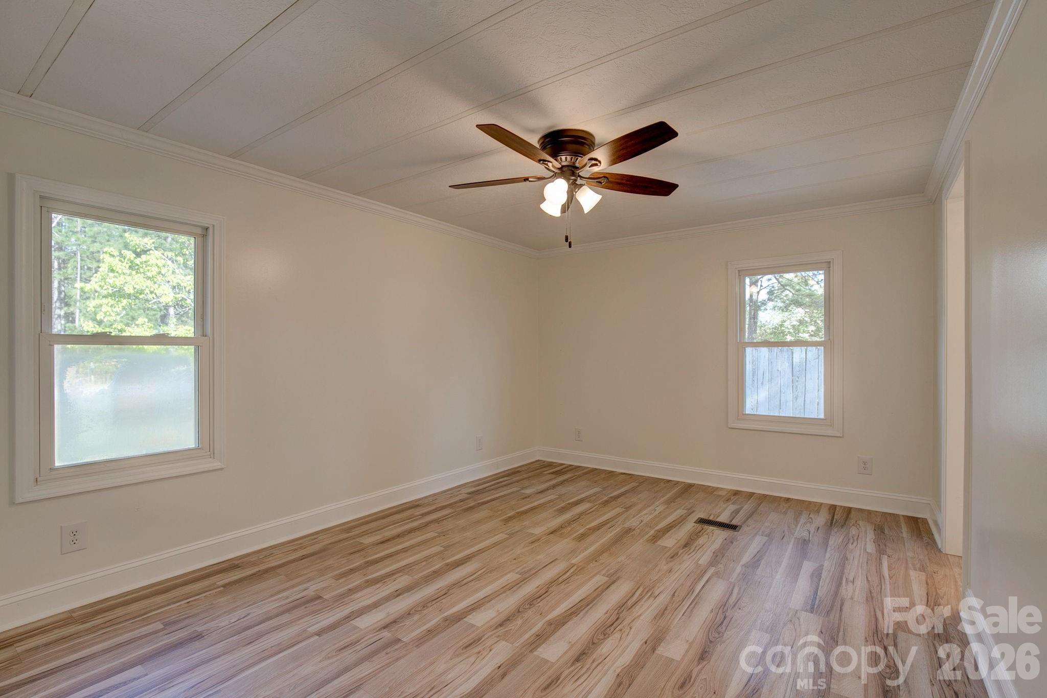4282 Fred Gardner Road Kershaw, SC 29067 - Photo 18 of 36 a view of empty room with wooden floor and fan