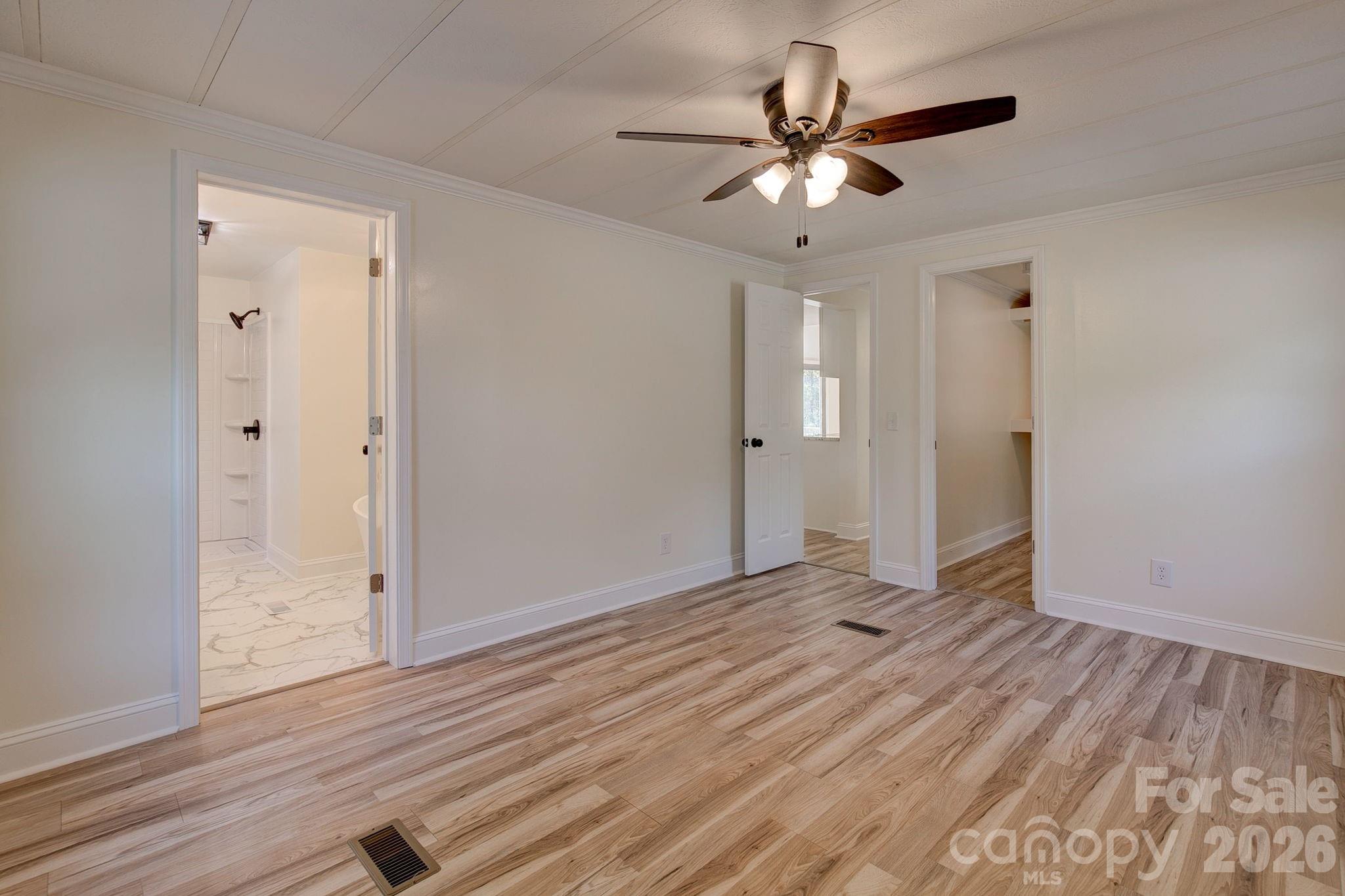 4282 Fred Gardner Road Kershaw, SC 29067 - Photo 20 of 36 an empty room with wooden floor and ceiling fan