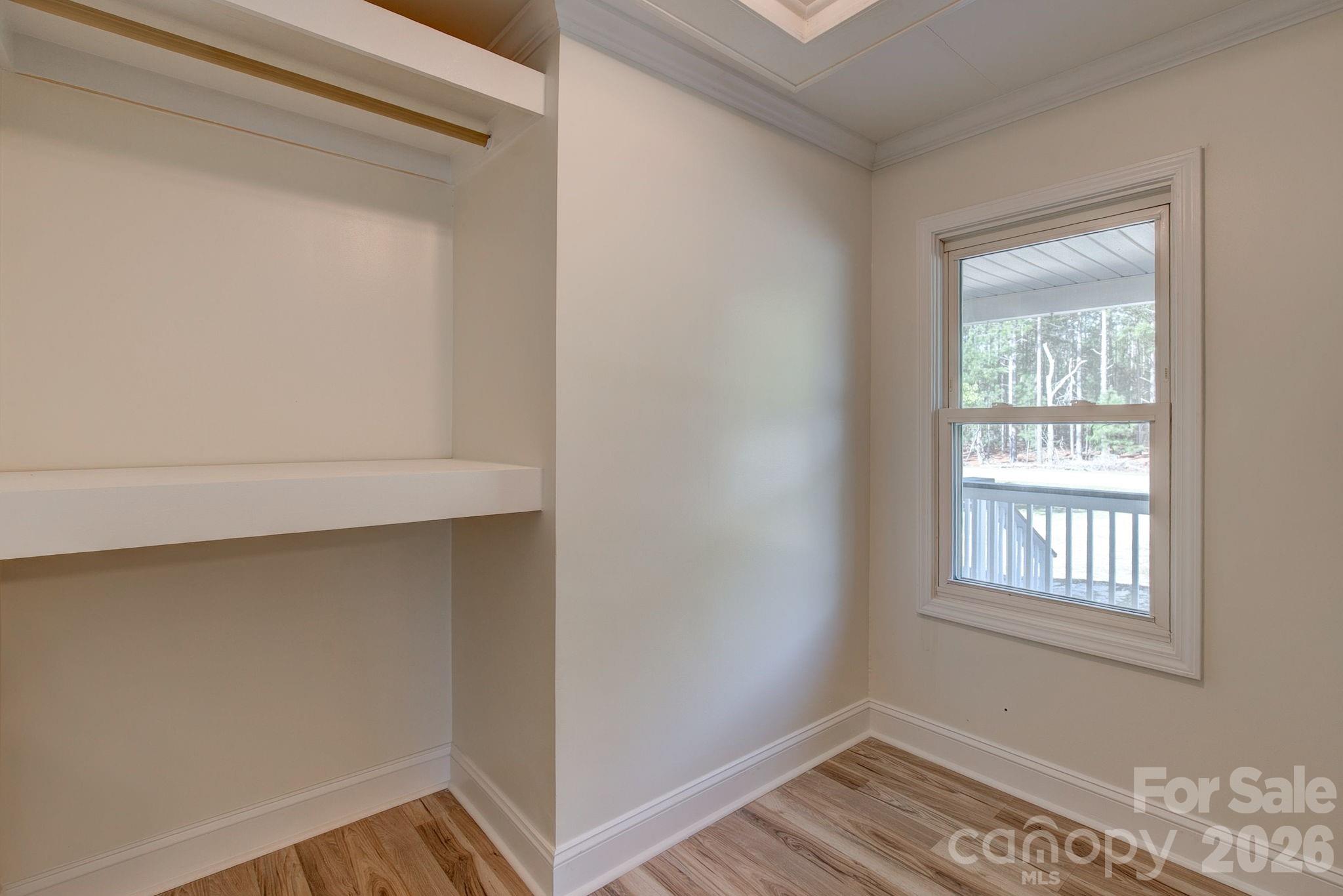 4282 Fred Gardner Road Kershaw, SC 29067 - Photo 22 of 36 a view of an empty room with wooden floor and a window