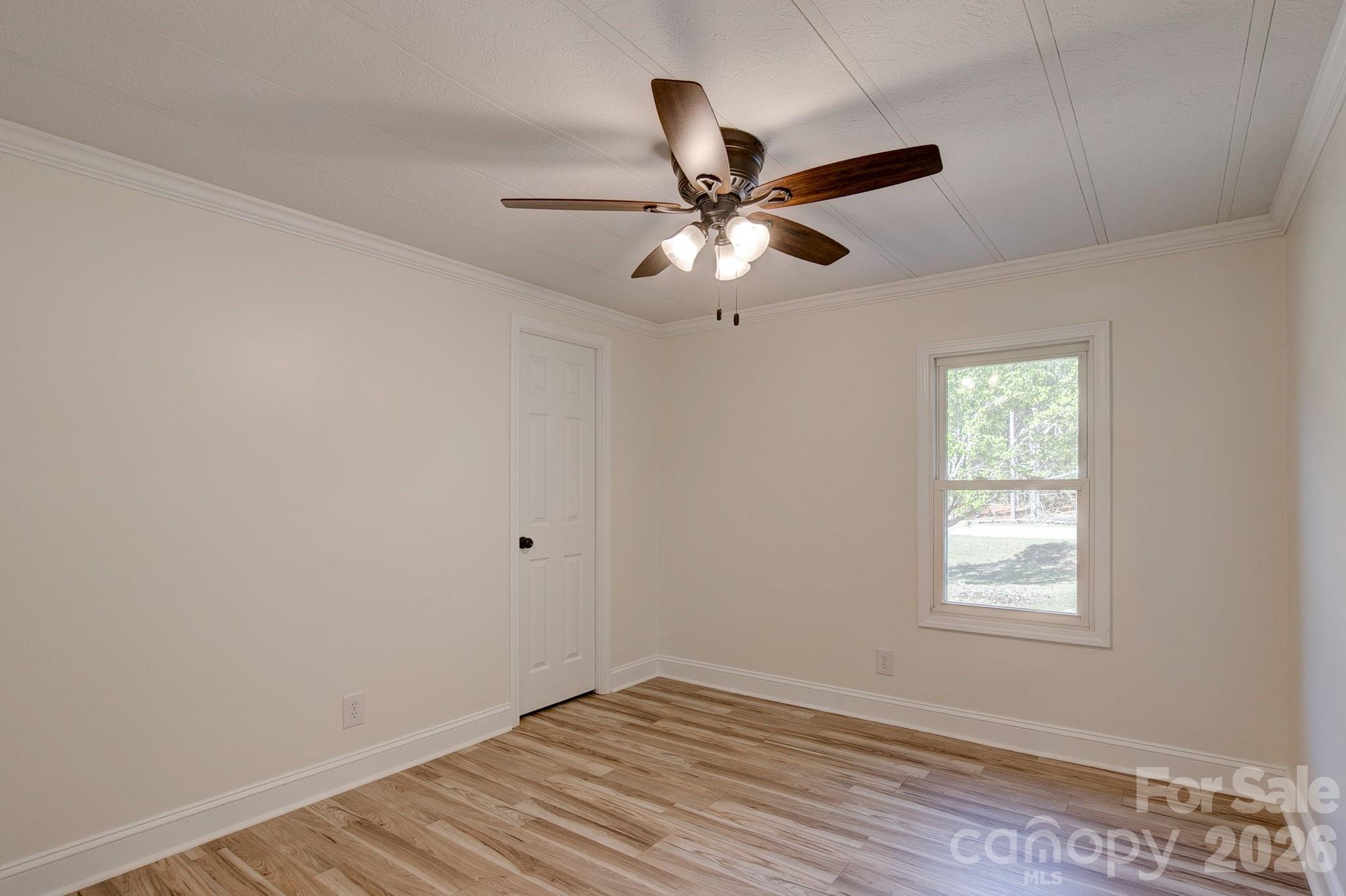 4282 Fred Gardner Road Kershaw, SC 29067 - Photo 27 of 36 a view of an empty room with window and chandelier fan