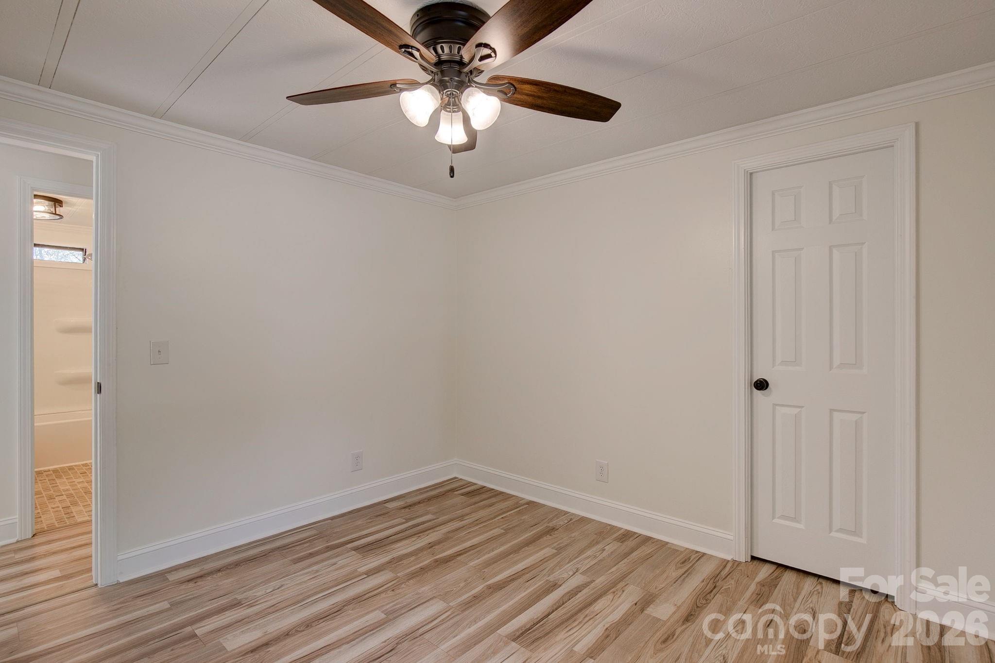 4282 Fred Gardner Road Kershaw, SC 29067 - Photo 28 of 36 wooden floor in an empty room with a chandelier fan