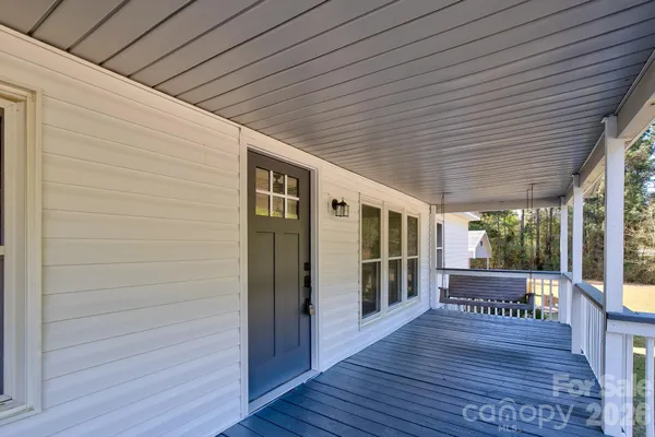 a view of a house with wooden deck