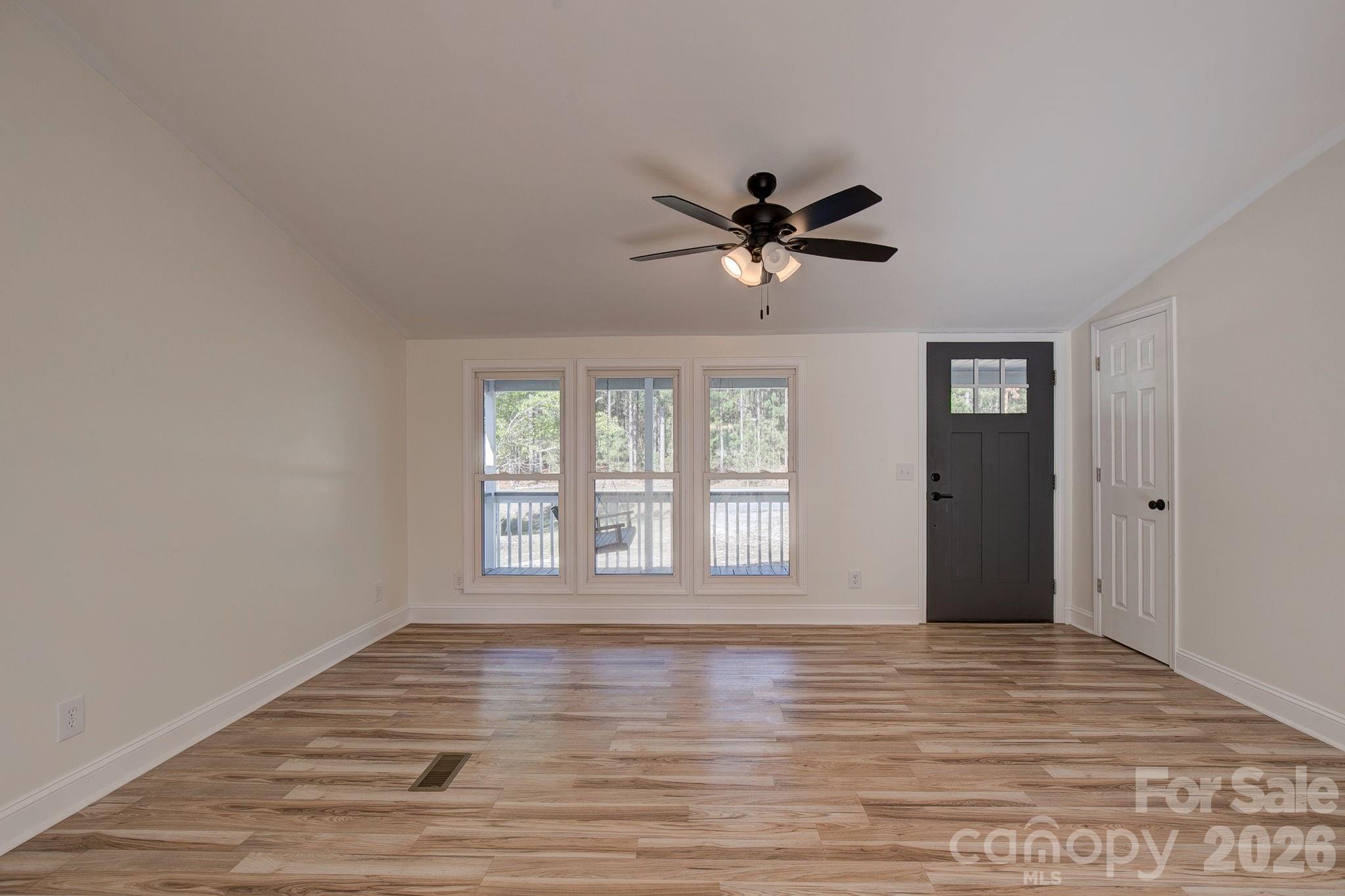 4282 Fred Gardner Road Kershaw, SC 29067 - Photo 6 of 36 a view of an empty room with a window and wooden floor