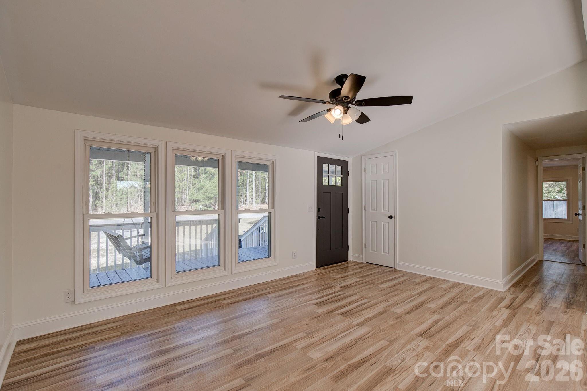 4282 Fred Gardner Road Kershaw, SC 29067 - Photo 7 of 36 a view of an empty room with a window and a kitchen