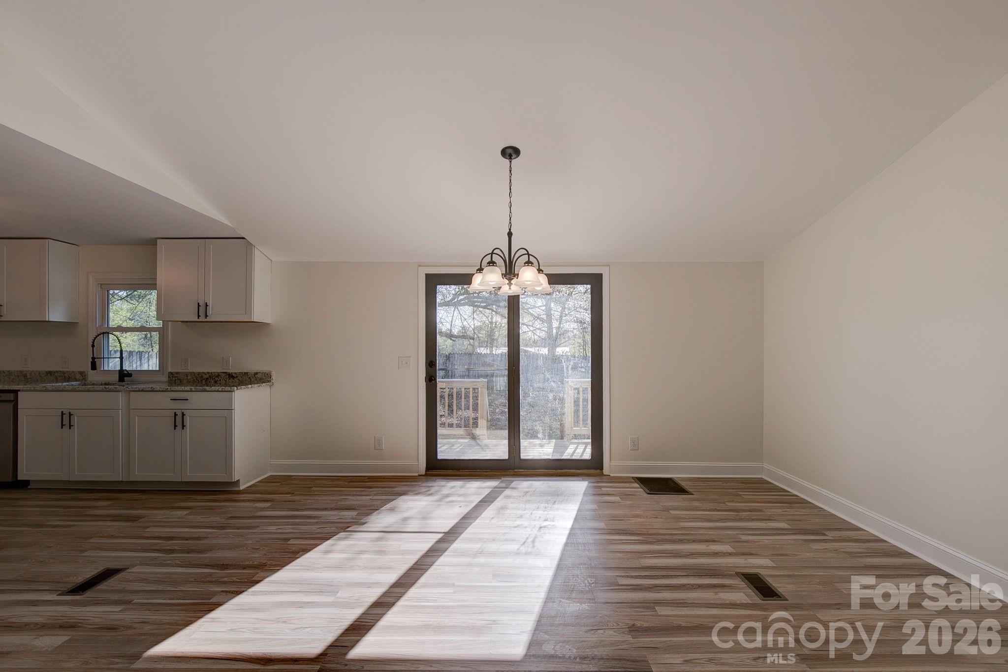 4282 Fred Gardner Road Kershaw, SC 29067 - Photo 9 of 36 a view of a kitchen with a sink and dishwasher with wooden floor