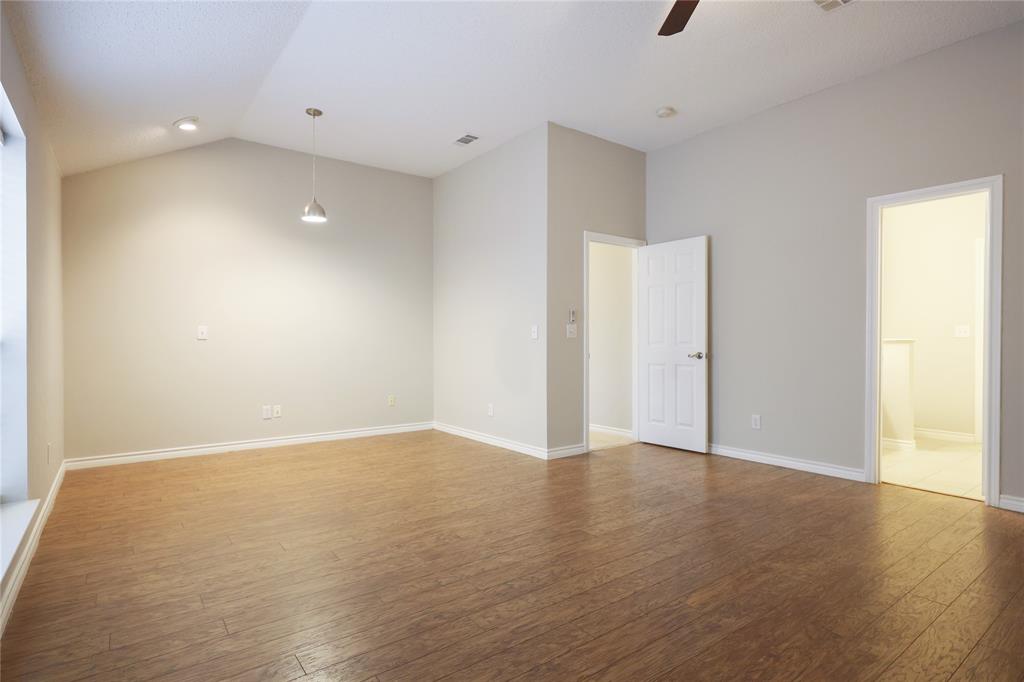 8112 Dock Street Frisco, TX 75035 - Photo 18 of 34 an empty room with wooden floor and windows