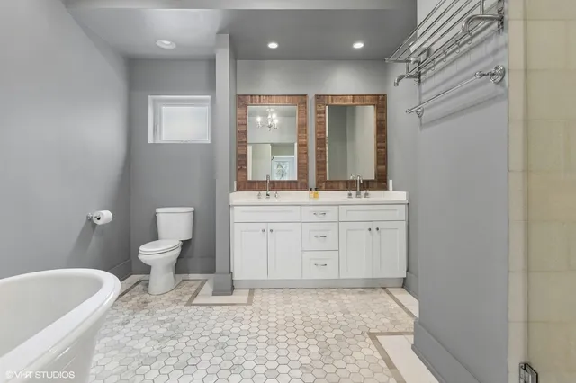a bathroom with a sink a toilet and tub