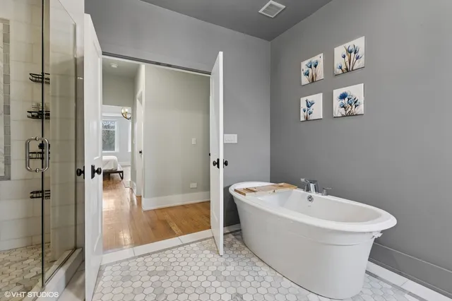 a white bath tub sitting next to a bathroom sink