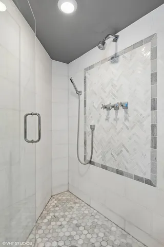a bathroom with a glass shower door