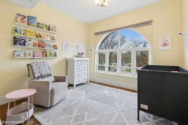 a living room with furniture a large window and a bookshelf