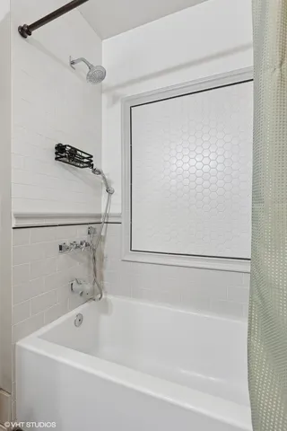 a bathroom with a bathtub and a shower