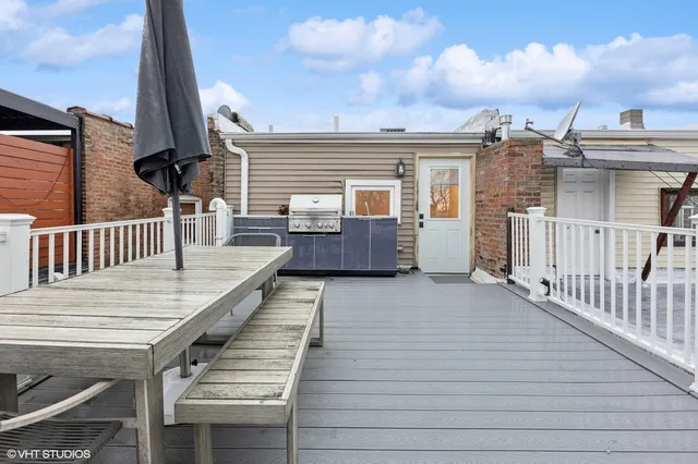 a view of a deck with wooden floor and fence