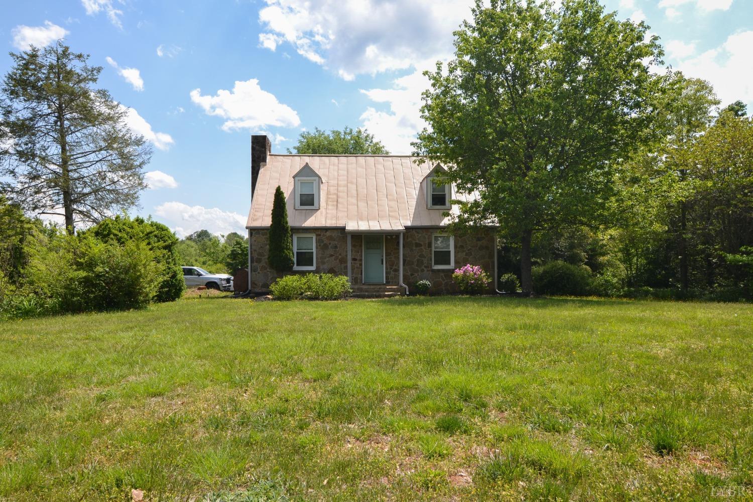 2245 Cedar Gate Road Madison Heights, VA 24572 - Photo 1 of 17 a front view of a house with garden