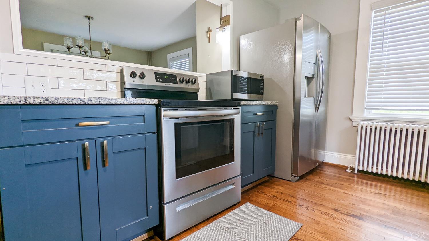 2245 Cedar Gate Road Madison Heights, VA 24572 - Photo 8 of 17 a kitchen with stainless steel appliances granite countertop a stove a washer and dryer
