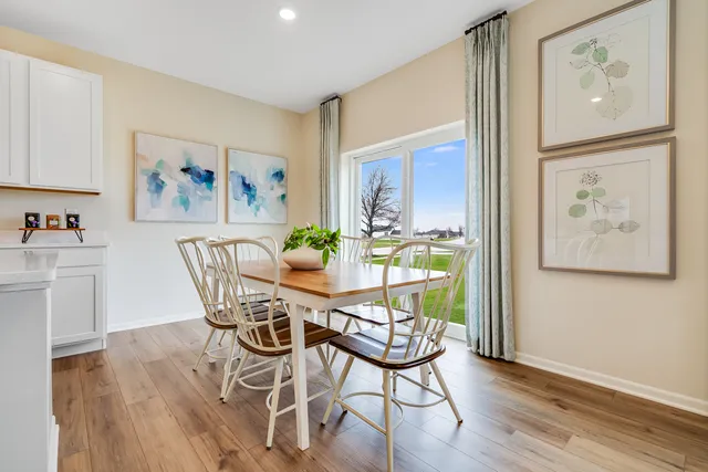 a view of a dining room with furniture wooden floor and a window