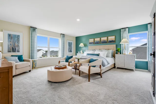 a bedroom with furniture and a large window