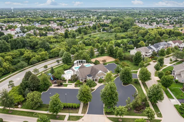 an aerial view of residential houses with outdoor space and street view