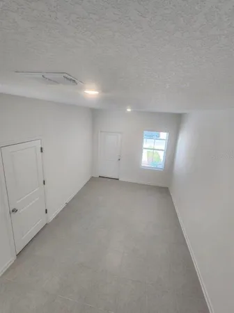 a view of an empty room and a window