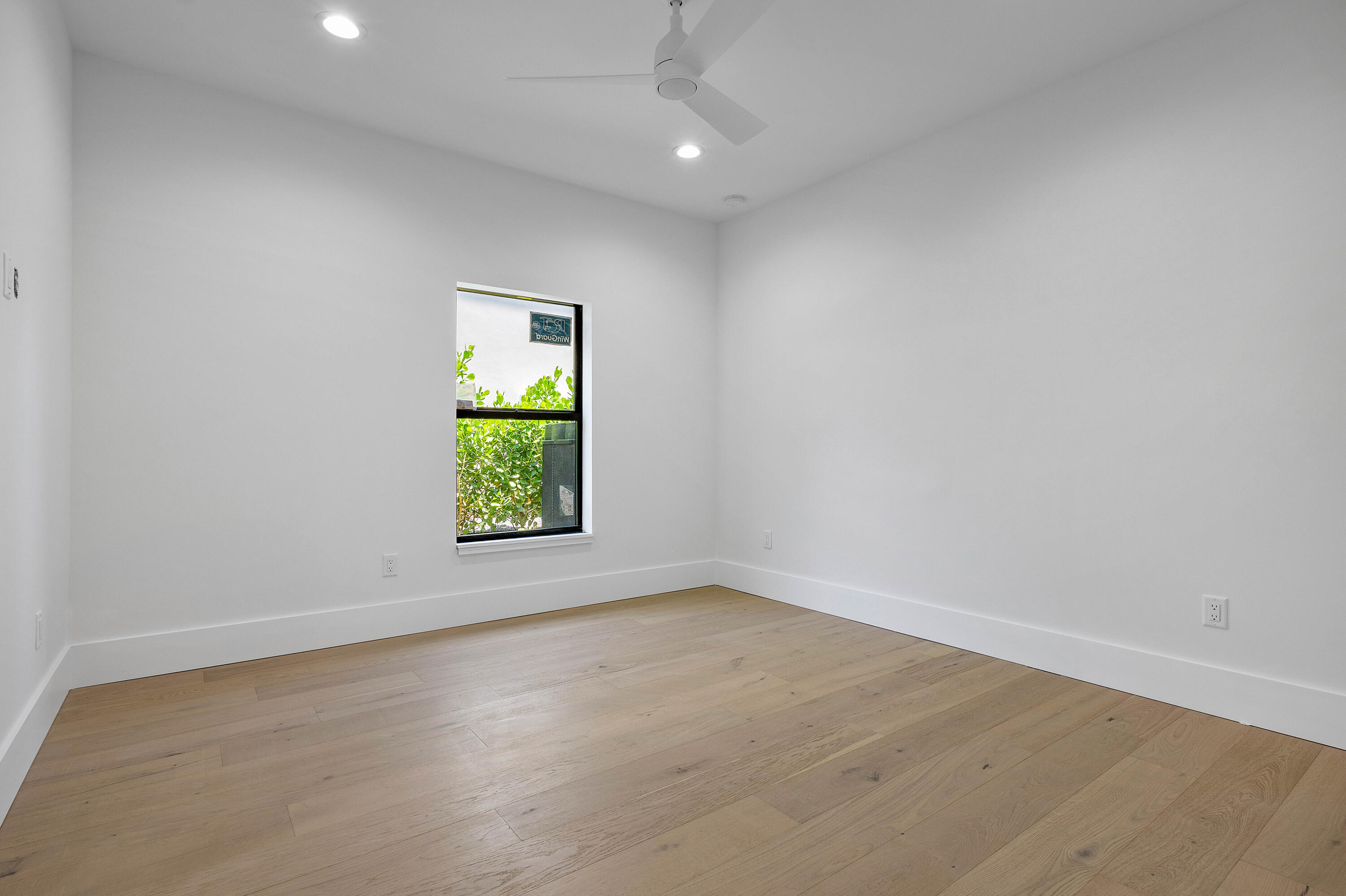 7536 Fenwick Place Boca Raton, FL 33496 - Photo 18 of 30 wooden floor in an empty room with a window