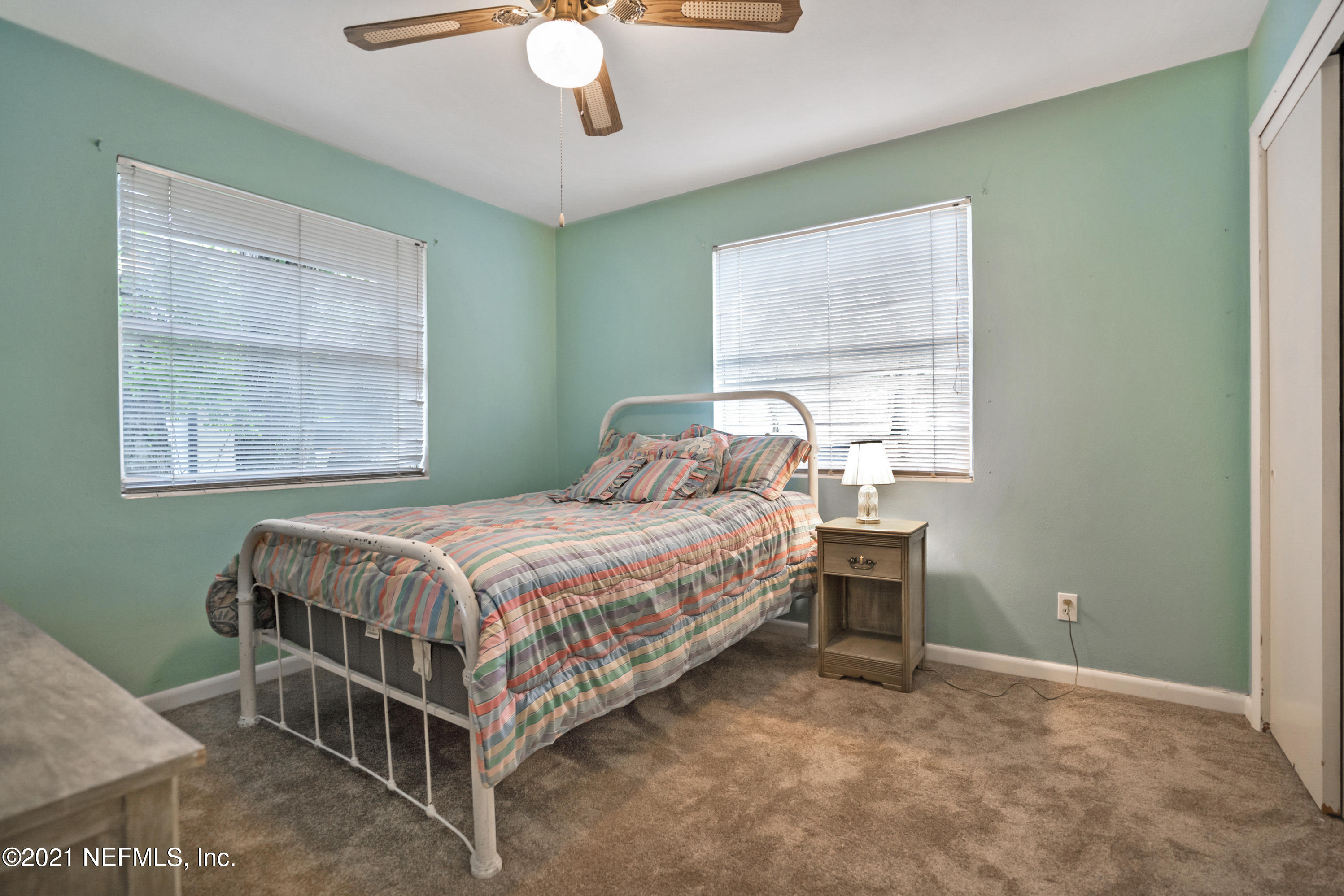 4004 Rogero Road Jacksonville, FL 32277 - Photo 12 of 19 a bedroom with a bed and window