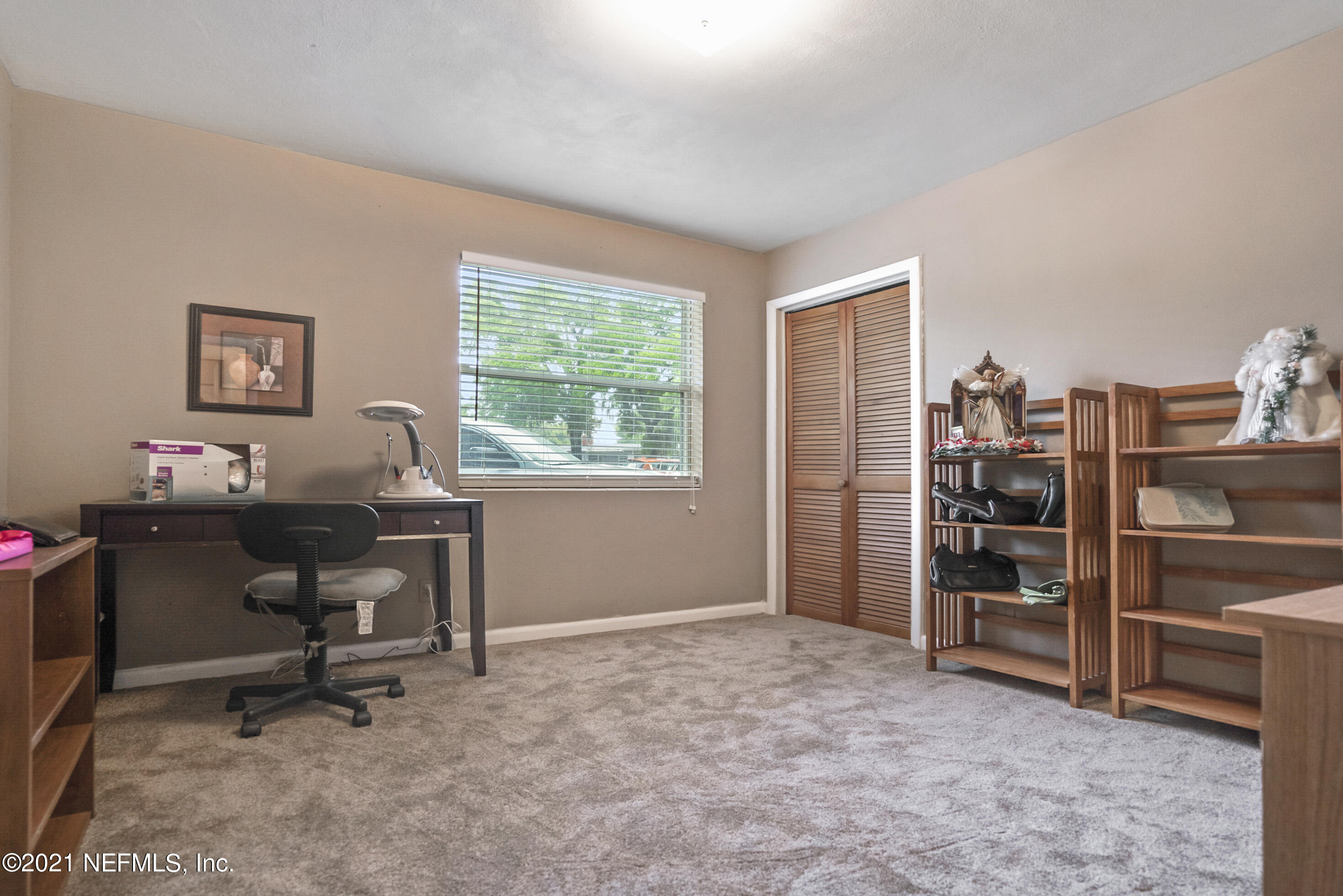 4004 Rogero Road Jacksonville, FL 32277 - Photo 13 of 19 a view of a workspace with furniture and a window