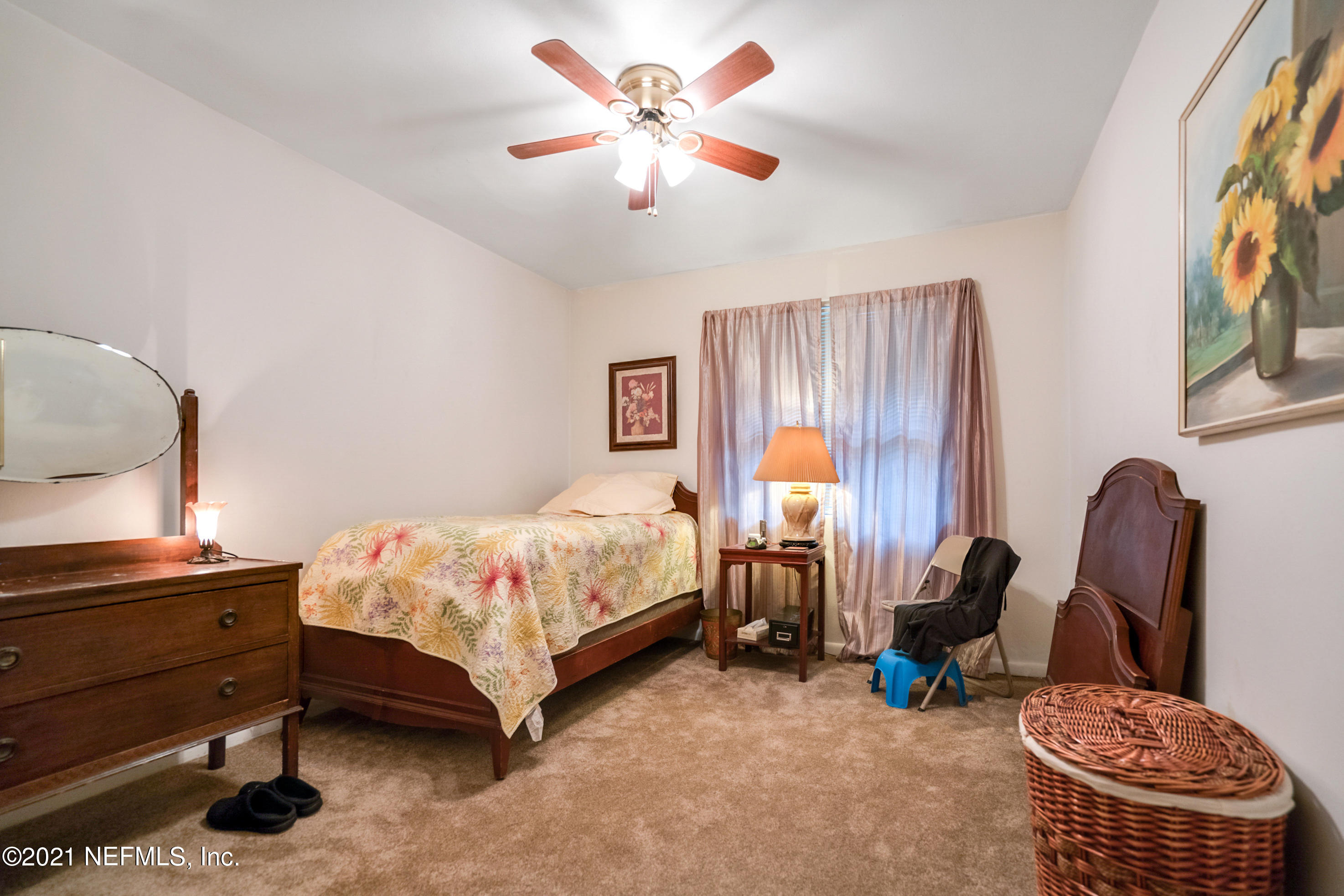 4004 Rogero Road Jacksonville, FL 32277 - Photo 14 of 19 a bedroom with a bed chair and a window
