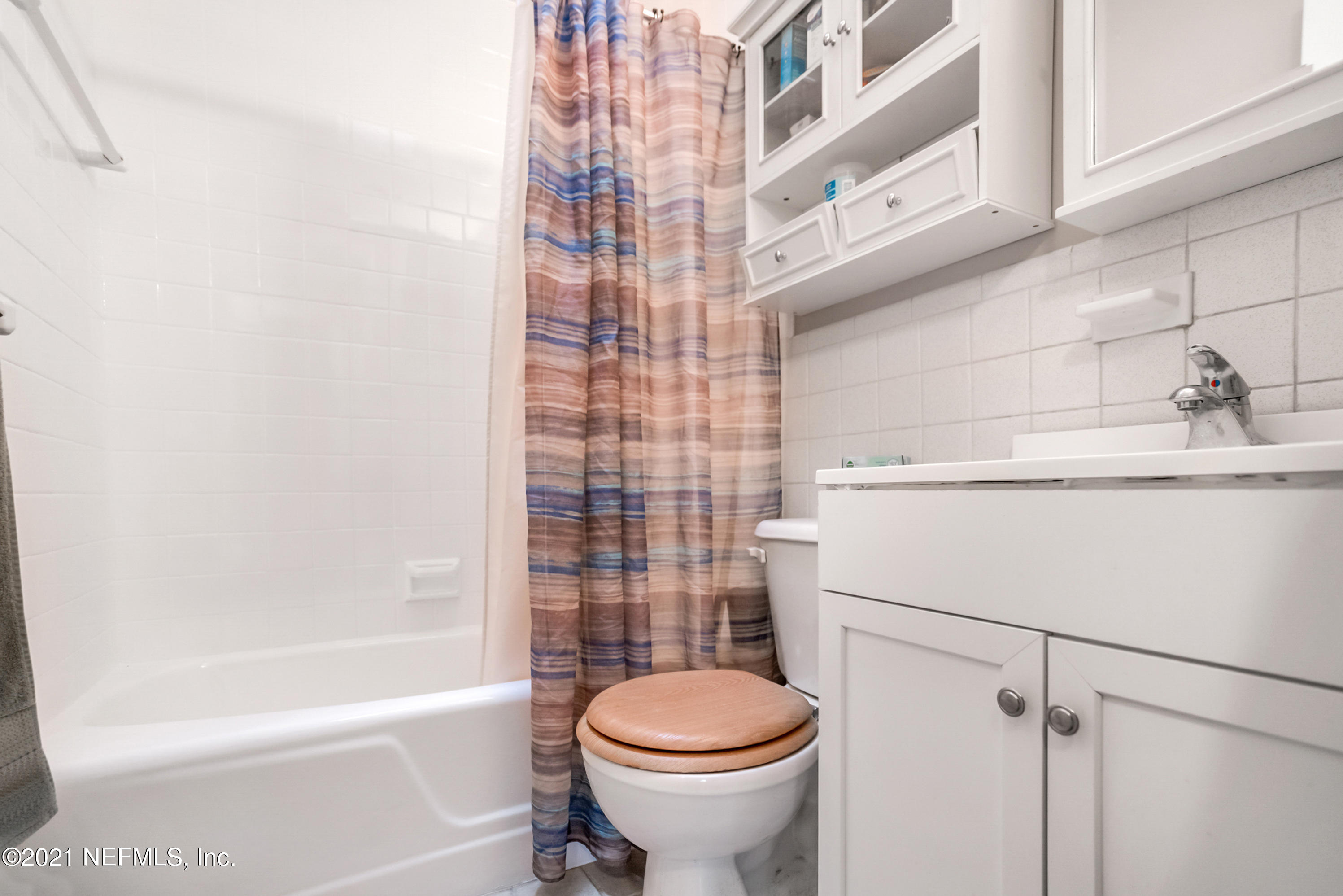 4004 Rogero Road Jacksonville, FL 32277 - Photo 16 of 19 a bathroom with a sink toilet and shower