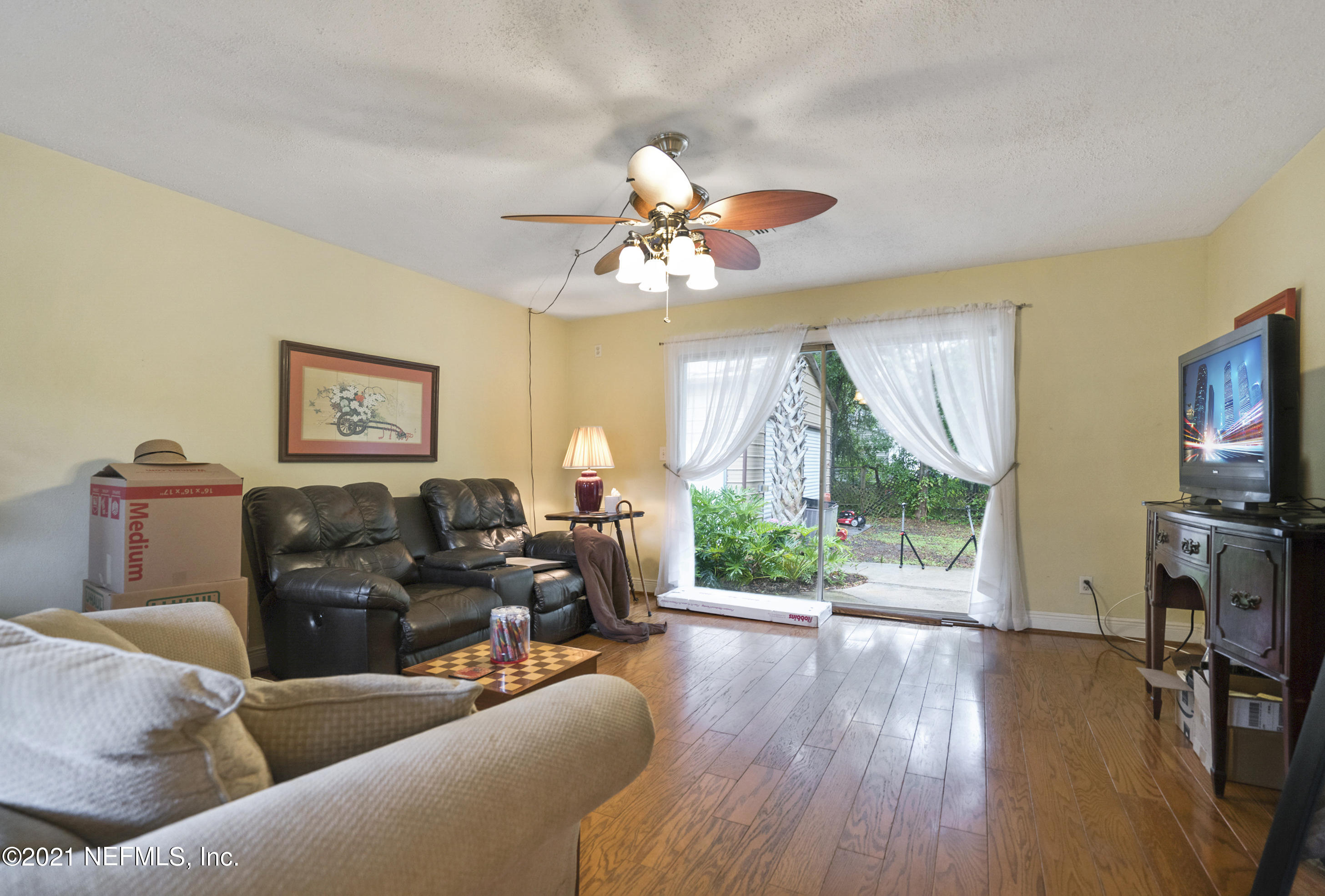 4004 Rogero Road Jacksonville, FL 32277 - Photo 3 of 19 a living room with furniture a fireplace and a flat screen tv