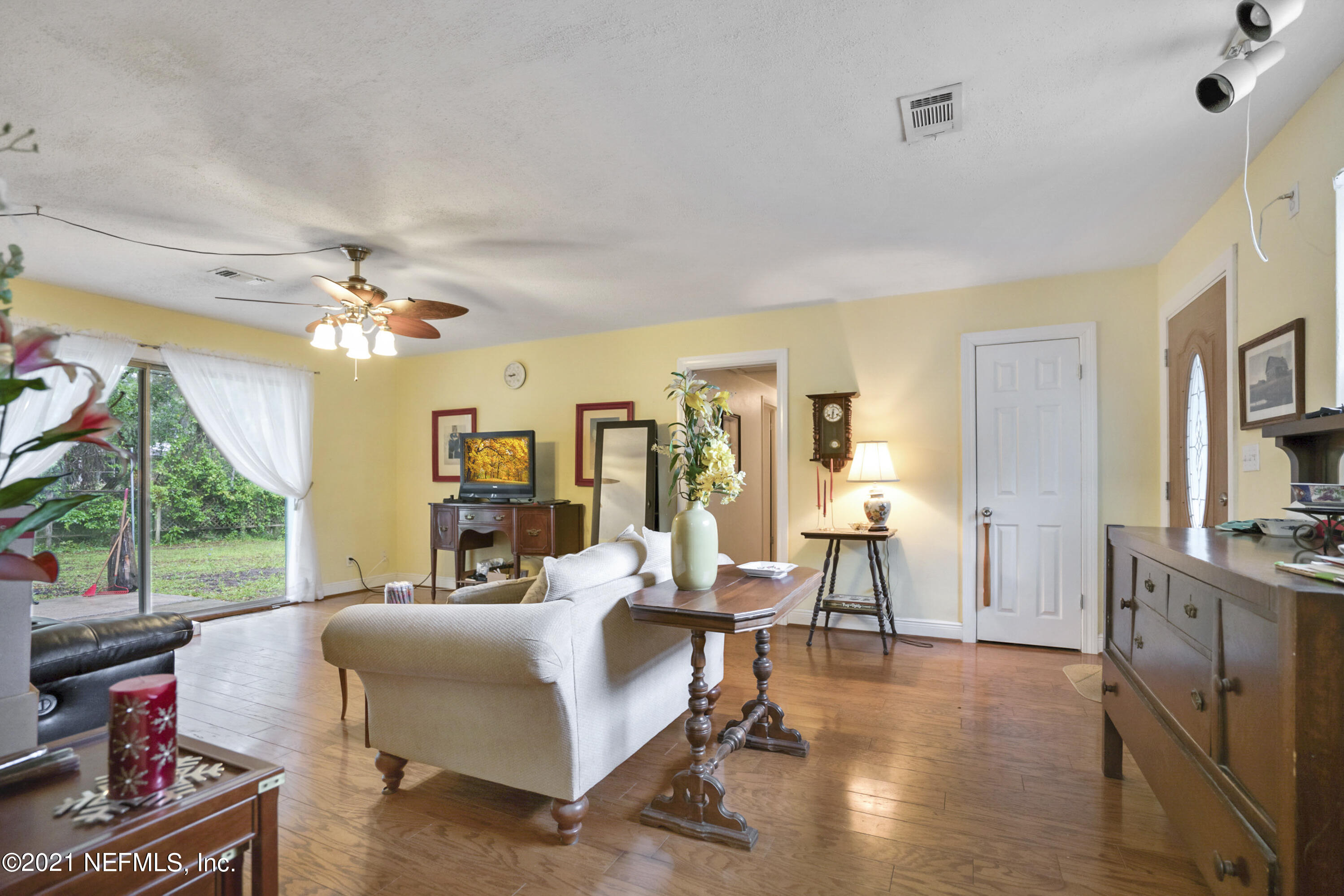 4004 Rogero Road Jacksonville, FL 32277 - Photo 5 of 19 a living room with furniture and a flat screen tv